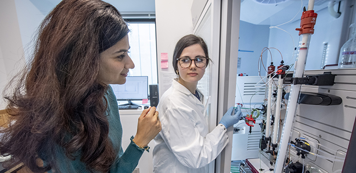 two women in lab using equipment